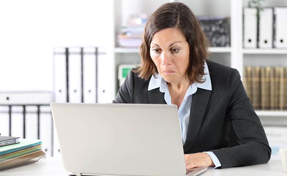 woman looking surprised at laptop