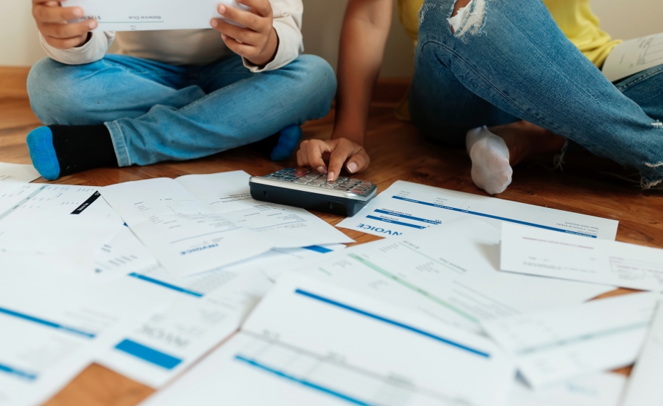 Young couple looking at paper bills to set up personal 