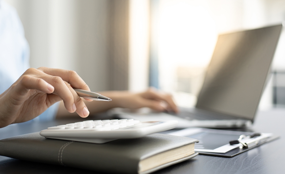 Person using calculator to add up money market savings