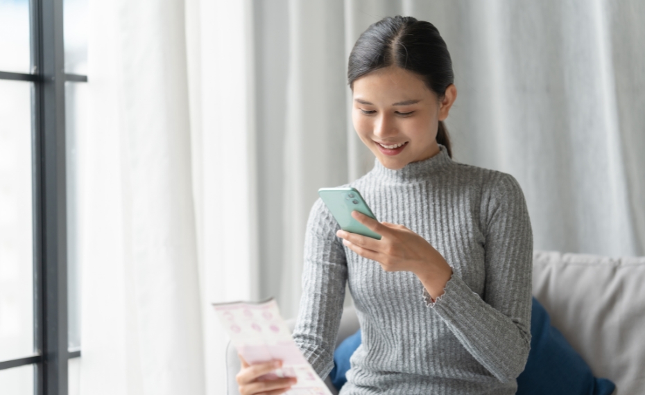 Woman checking savings balance using mobile app on phone