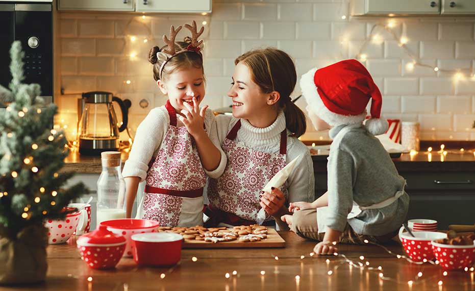 young family making holiday cookies