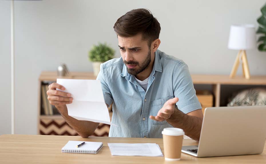 person puzzled looking at papers