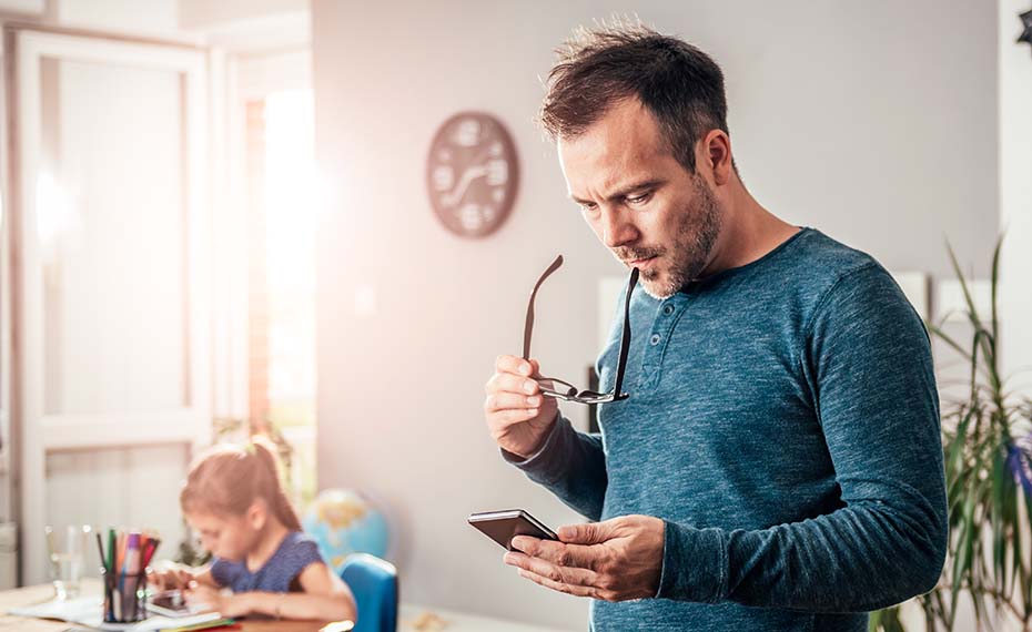 father looking at phone