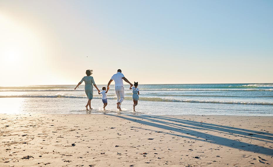 family on beach at sunset